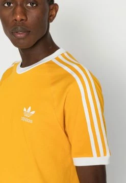 Adidas Originals STRIPES TEE UNISEX - Print T-shirt - Yellow -Adidas Originals Shop 169b61cbe27d4fdf94e7e608ce438d18