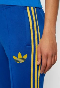 Adidas Originals FLARED 70S PACK - Tracksuit Bottoms - Collegiate Royal -Adidas Originals Shop 8f9e87a1369e432cbdf733fb69d48731